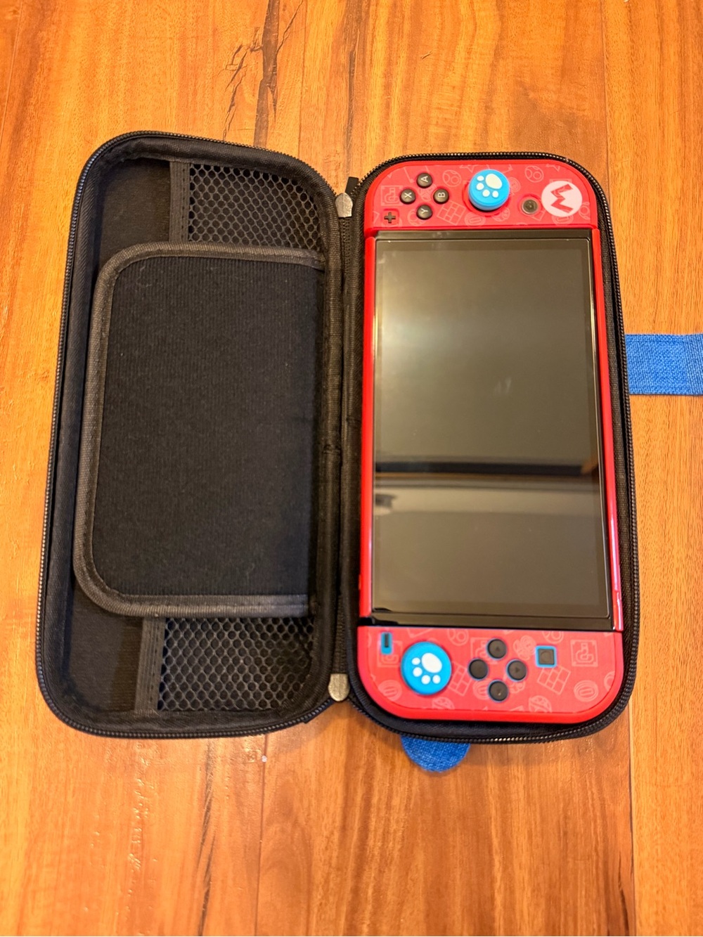 Nintendo Red Handheld Console with Blue Thumb Grips